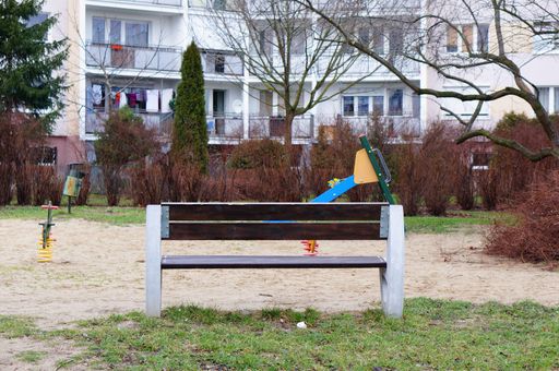 Wooden park bench by play ground