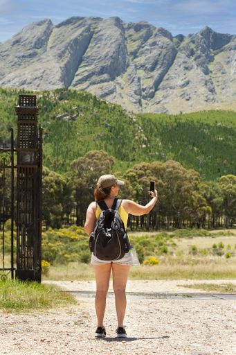 A middle-aged Argentinian woman taking a photo in the Ernesto Tornquist Provincial Park