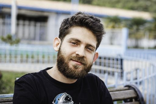 A closeup shot of a handsome Hispanic bearded man in the park