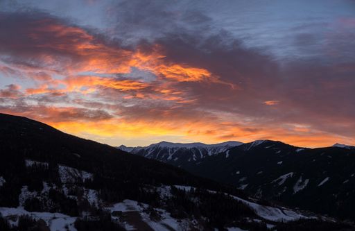 The mesmerizing view of the mountains covered in snow during sunrise