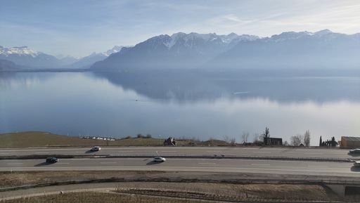 A view of the Geneva Lake and the Swiss Alps from Corsier, Lavaux, Switzerland