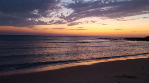 A beautiful shot of a calm empty beach at sunset