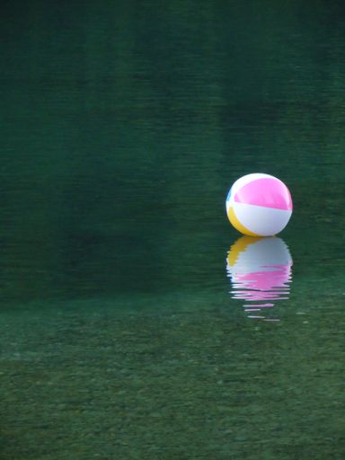 Colorful beach ball floating on the water