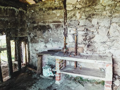 the interior of an old abandoned building with dark walls and rubbish