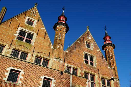 A low angle of an ancient historical building under a blue sky