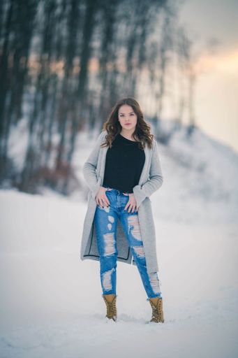 A fashionable Bosnian Caucasian woman looking at the camera with a serious face