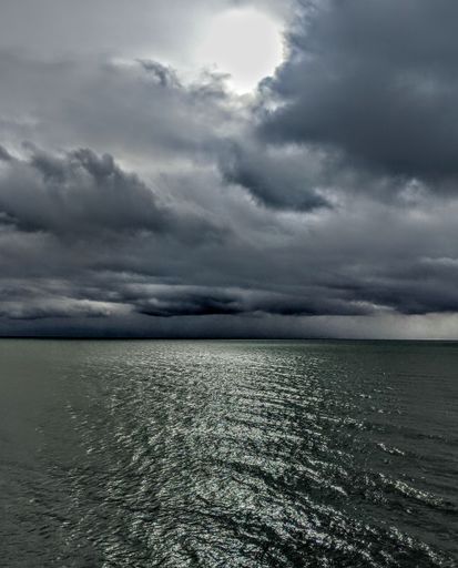 A dark cloudy sky hanging on the sea