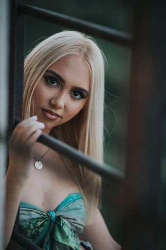 A sexy fashionable Bosnian Caucasian woman posing in an abandoned building