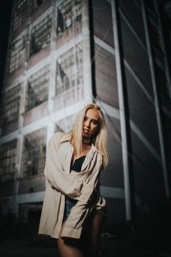 A sexy fashionable Bosnian Caucasian woman posing with an old abandoned building background