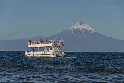 tourist boat on Lake Llanquihue and osorno volcano background