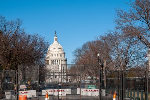 The Capitol Building surrounded by fences and razor wire