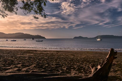 A closeup shot of ships sailing in the sea under a sunset in Costa Rica