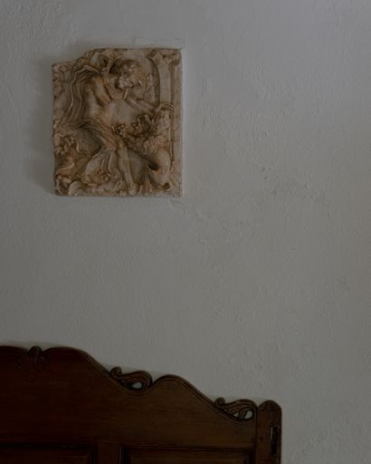 A closeup shot of an antique marble sculpture decoration attached to the wall in Palacio de Viana, Cordoba