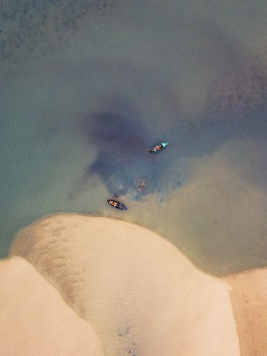 A vertical top view of fishing boats in the water in Portugal