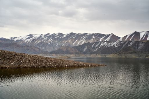 A beautiful scenic view of the Azat reservoir in Armenia with a snow-capped mountain range in the background