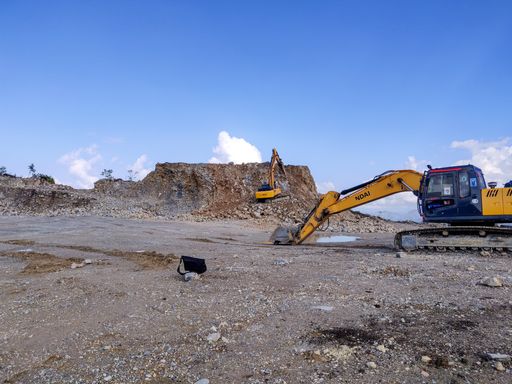 Excavators at work on a construction site on a hill in Nepal