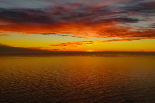 A mesmerizing view of the golden sunset over a tranquil sea - perfect for wallpaper