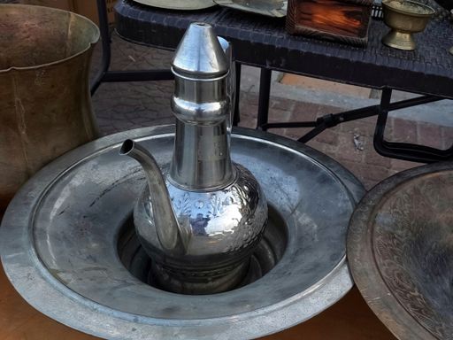 A closeup shot of a steel kettle in a big container