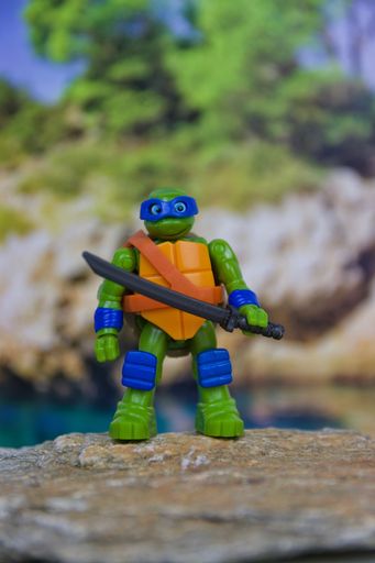 A Vertical shot of a ninja turtle figurine holding a sword