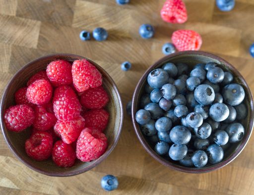 A closeup shot of fresh ripe raspberries and blueberries