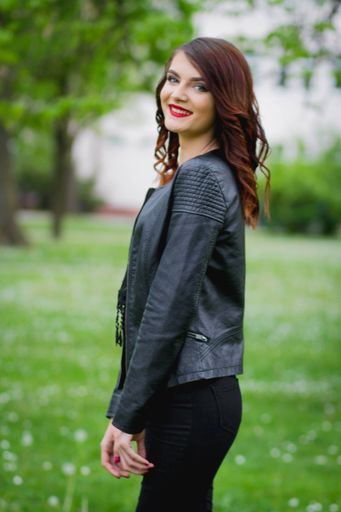A young Bosnian woman with red lipstick posing in the park