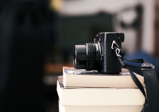 The vintage camera on a pile of books