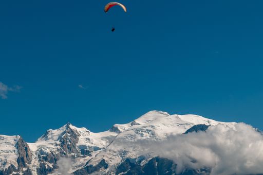 Paraglider against a blue sky with Mont Blanc in the background