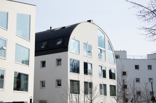 A modern building with many windows against the clear blue sky