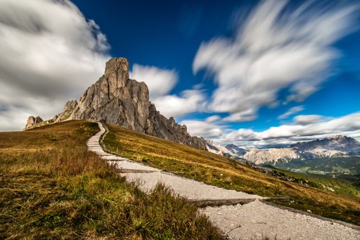 A landscape of hills and rocks covered in greenery under the sunlight and clouds with motion effect