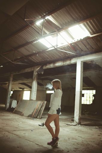 An attractive Bosnian Caucasian woman inside an old and abandoned building