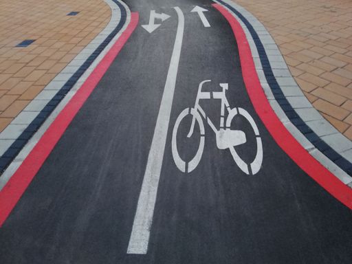 A bicycle street line track and arrow sign for the direction