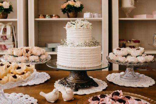 A closeup shot of chocolate candies with nuts in decorative flower buds and delicious white cake