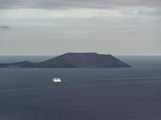 A white boat in the ocean on the volcanic island of Lanzarote, Canary Islands, Spain