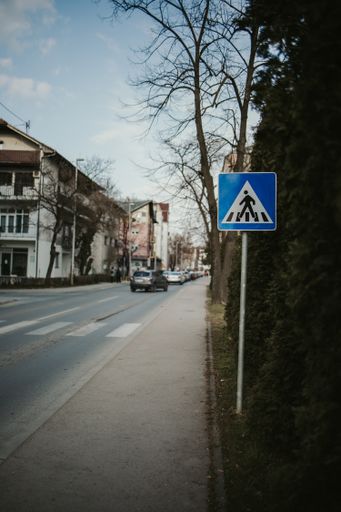 Crosswalk road sign on the street with traffi