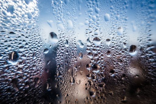 A window glass covered with raindrops - great for a cool background