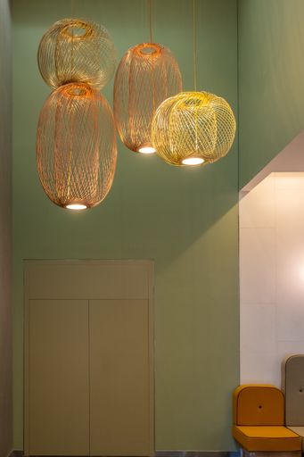 A vertical shot of two pair decorative lamps hanging from the ceiling