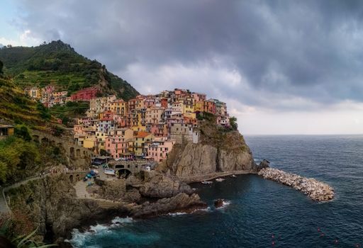 A beautiful view of manarola village in cinque terre italy with a gloomy sky in the background