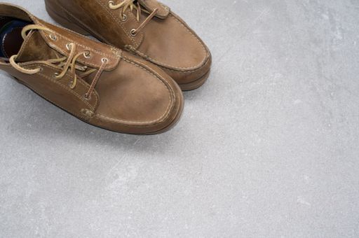 A closeup shot of comfortable brown shoes on a gray surface