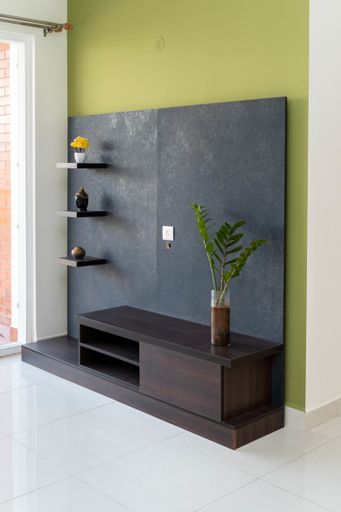 A TV stand with shelves houseplant and decors in the living room