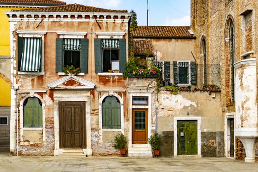 An old house with weathered exterior walls in Venice, Italy