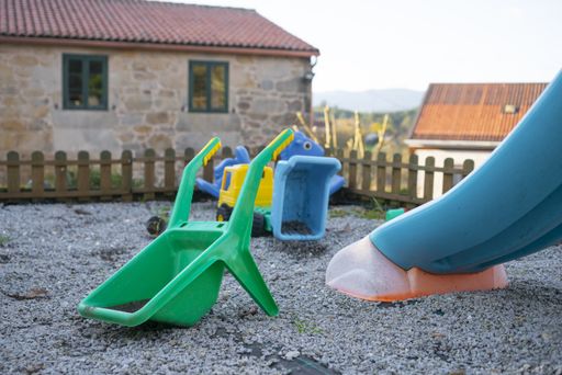 A closeup shot of abandoned colorful plastic farming dirty toys on the playground on a sunny day