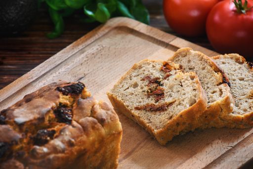 Sliced wheat rye sourdough bread stuffed with sun-dried tomatoes and rosemary.