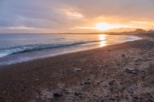 A beautiful sunset scenery at a sandy beach - great for wallpaper