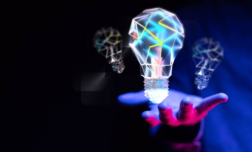 A person presenting a virtual projection of creative idea lamps - business success concept