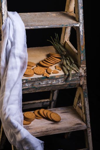 A vertical shot of tasty cookies on a rusty surface on a black background