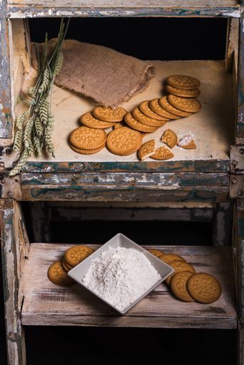 A vertical shot of tasty cookies on a rusty surface on a black background