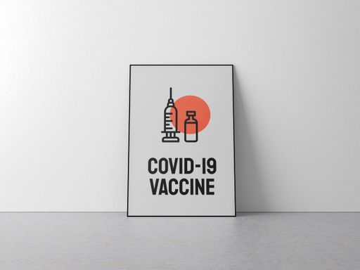 A COVID-19 Vaccine poster against a white wall