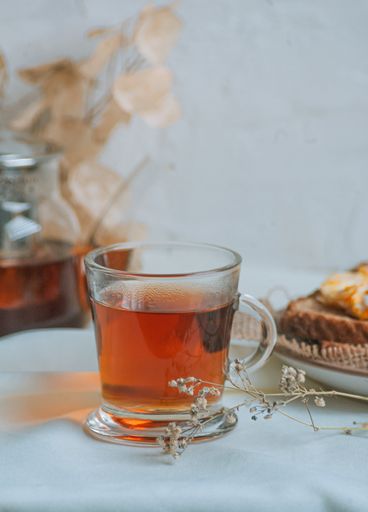 A vertical closeup shot of a cup of hot herbal tea