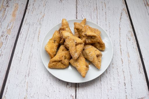 Top view of pestinos on a plate and white table
