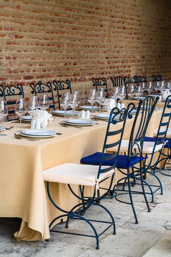 A vertical shot of a festive table setting with wine glasses and white plates